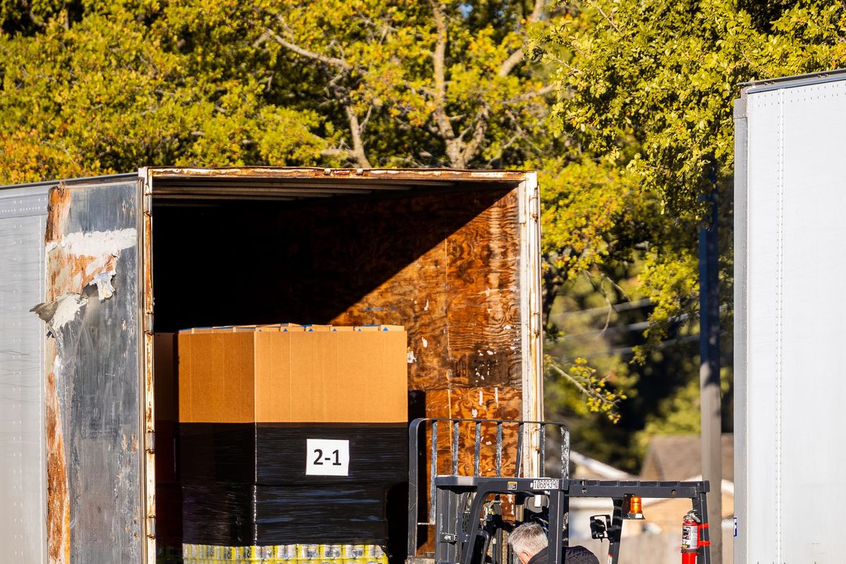 Forklift loading a pallet onto a truck