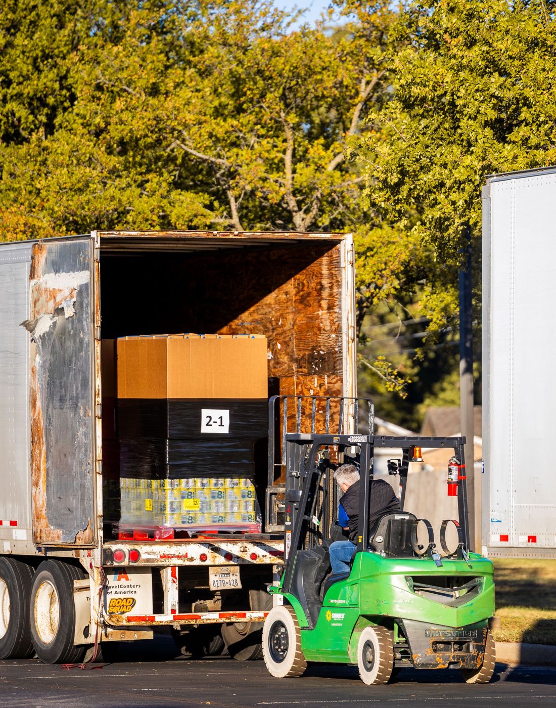 Forklift loading a pallet onto a truck