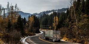 Truck on a road through a snowy mountain pass
