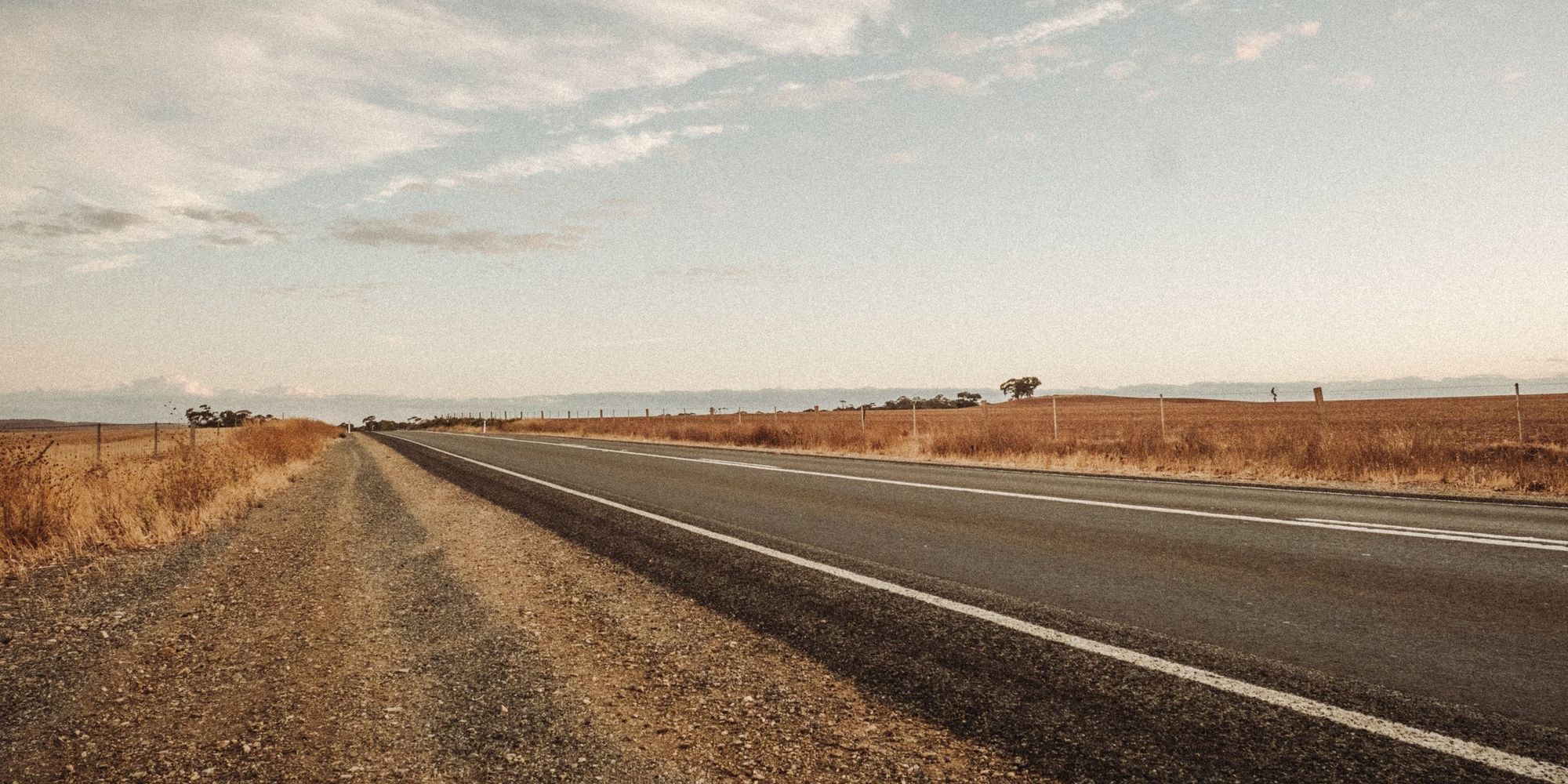Open highway stretching through fields