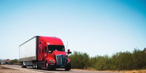 Red tractor-trailer on a highway
