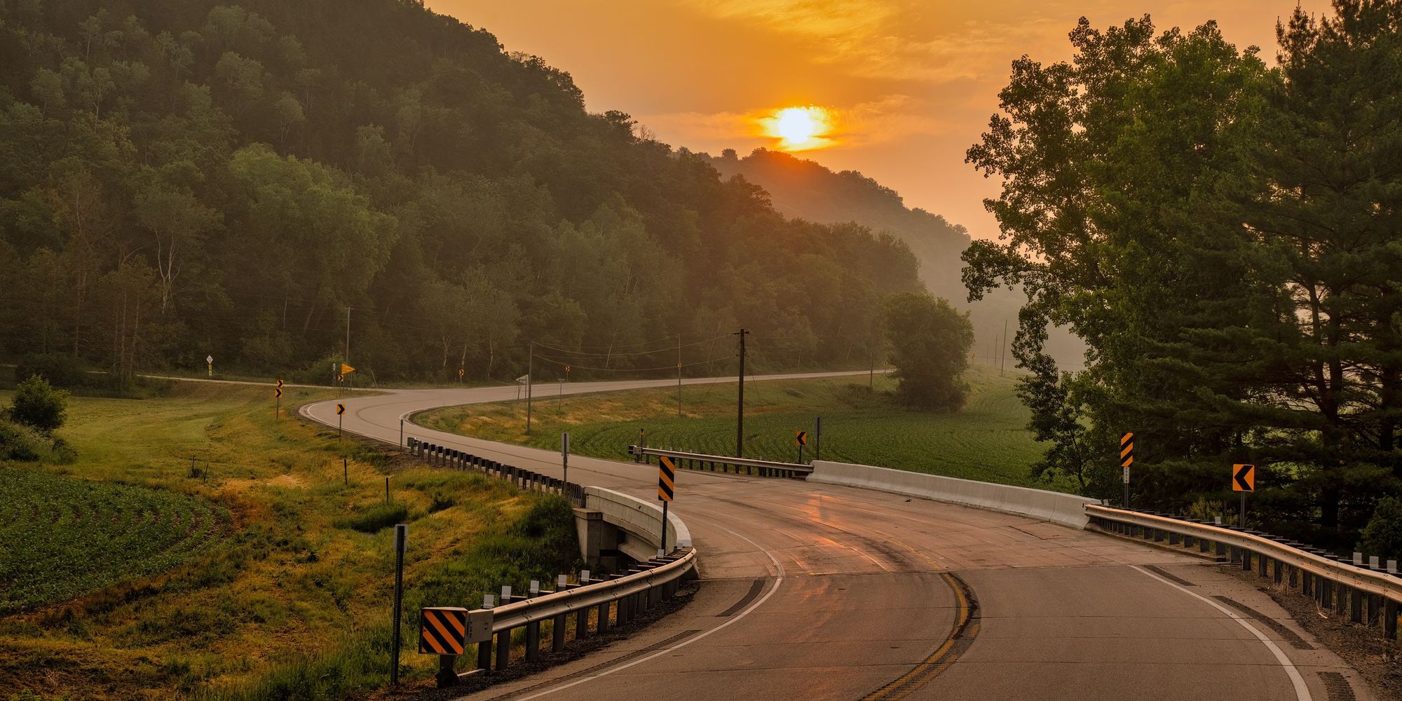 Winding rural road at sunset