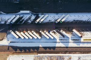 Aerial view of tractor-trailers parked in rows at a truck lot